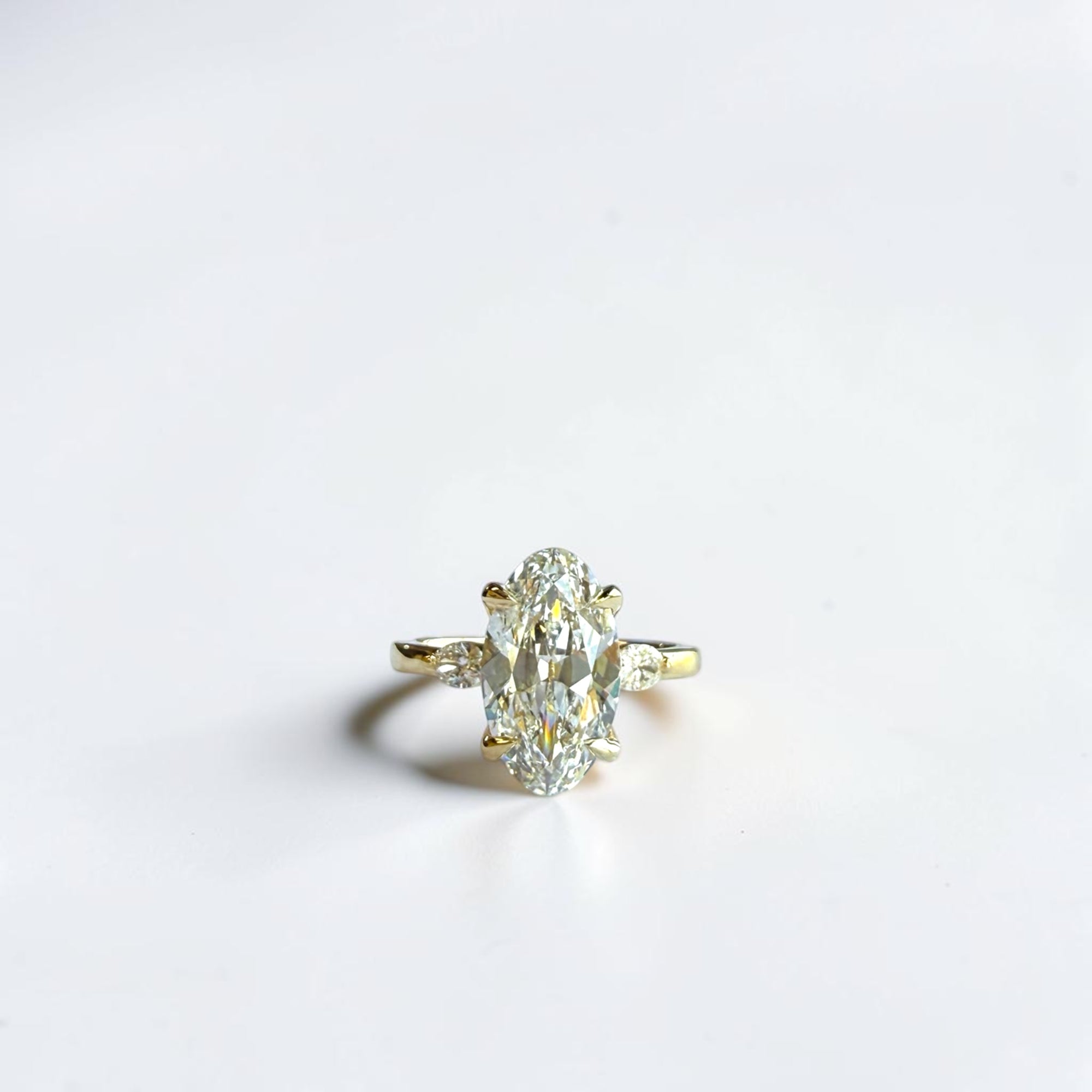 3.12 carat D VVS2 IGI lab elongated old mine moval three stone ring with hidden halo in 14k yellow gold — Cherry Pick Diamonds Clayton MO