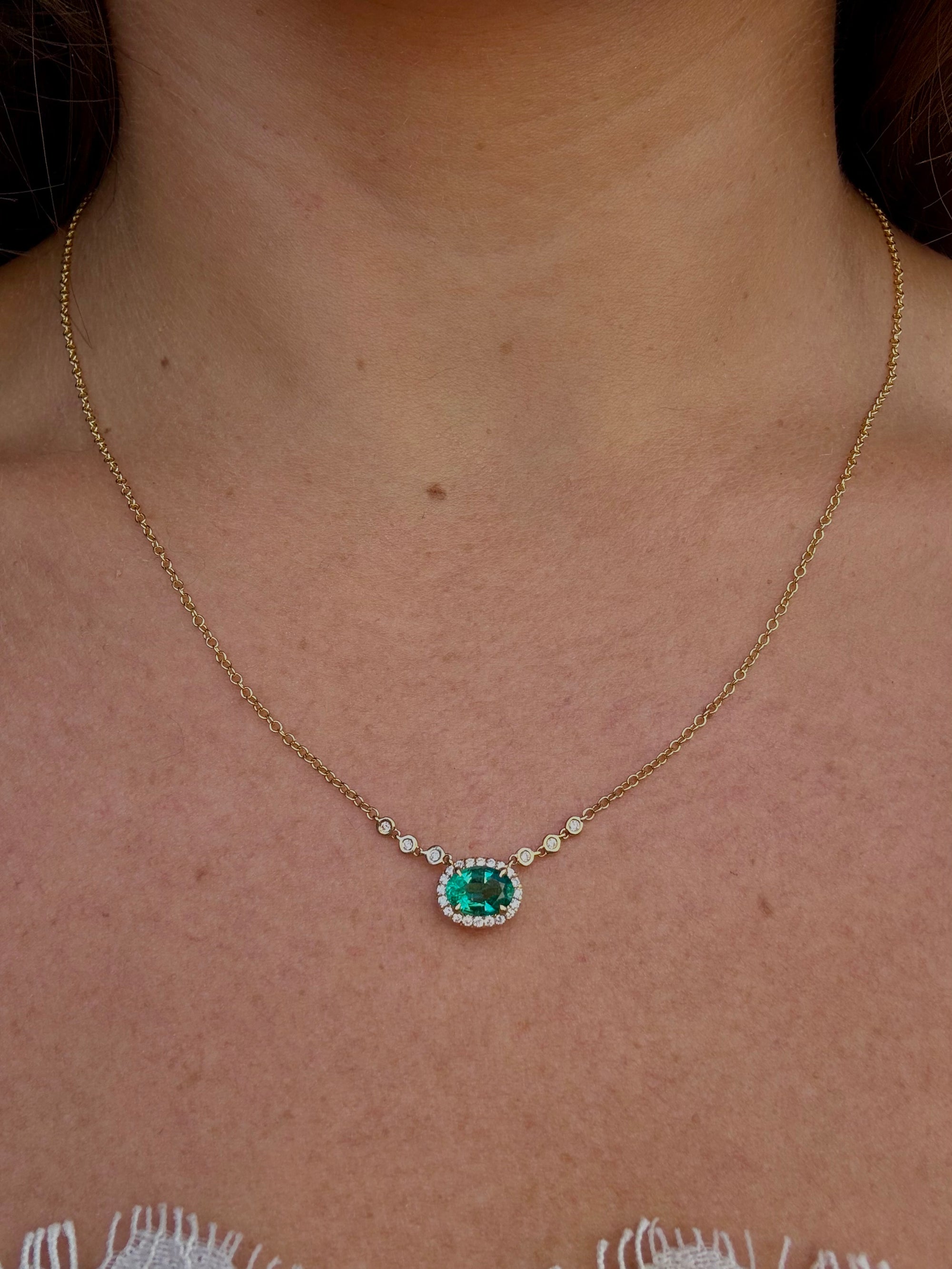 0.66 carat Colombian emerald oval diamond halo pendant necklace in 18K yellow gold, Cherry Pick Diamonds Clayton MO