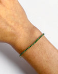 Natural Colombian emerald bracelet detail, round green emeralds in yellow gold - Cherry Pick Diamonds