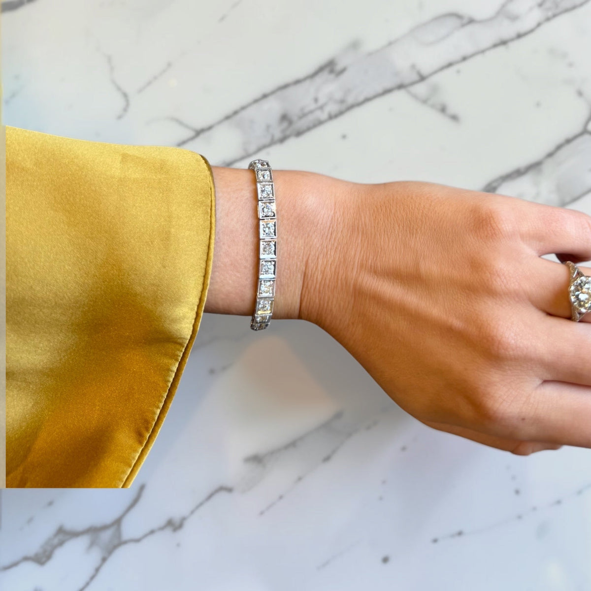 Close-up of antique-style milgrain detail on old European cut diamond tennis bracelet