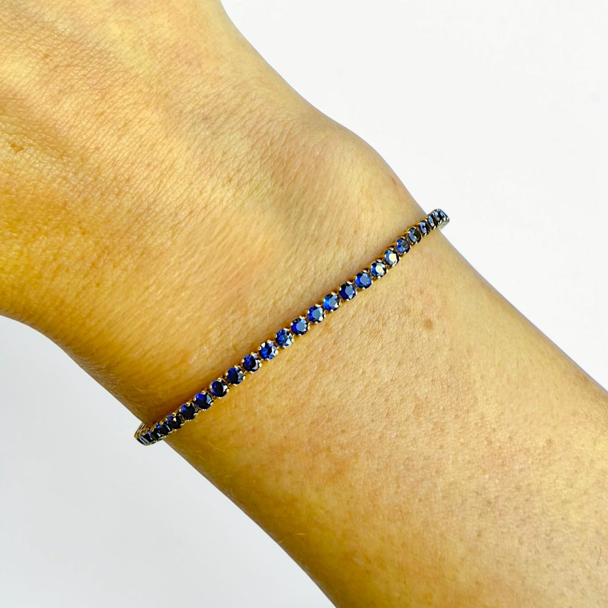 Natural sapphire bracelet detail, round royal blue sapphires in yellow gold - Cherry Pick Diamonds