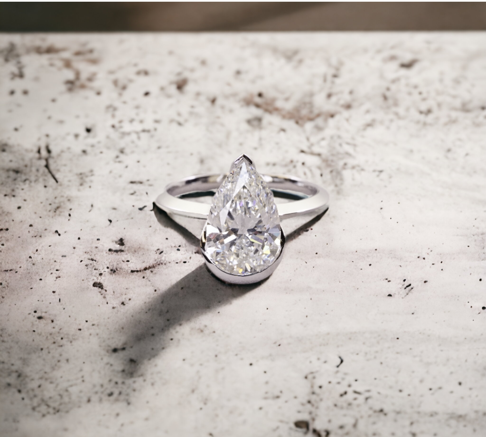 Monaco WG engagement ring in white gold with knife edge half bezel for pear shape diamond – Cherry Pick Diamonds Clayton St. Louis MO