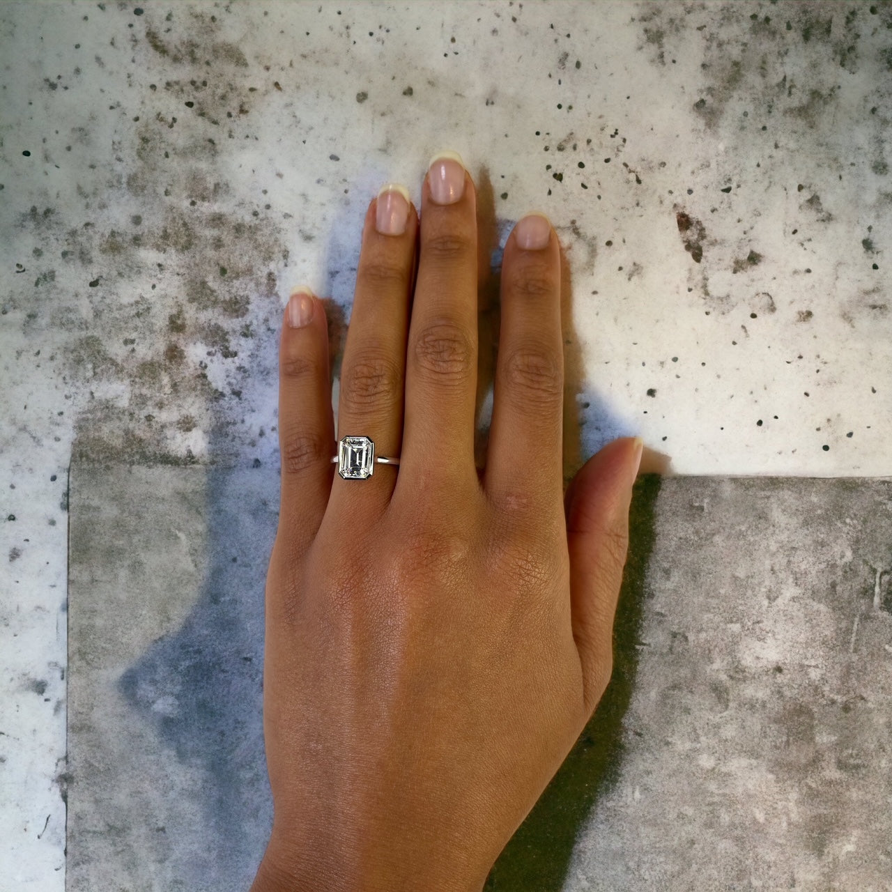 Bergamo WG engagement ring close-up, white gold bezel emerald cut – Cherry Pick Diamonds Clayton MO