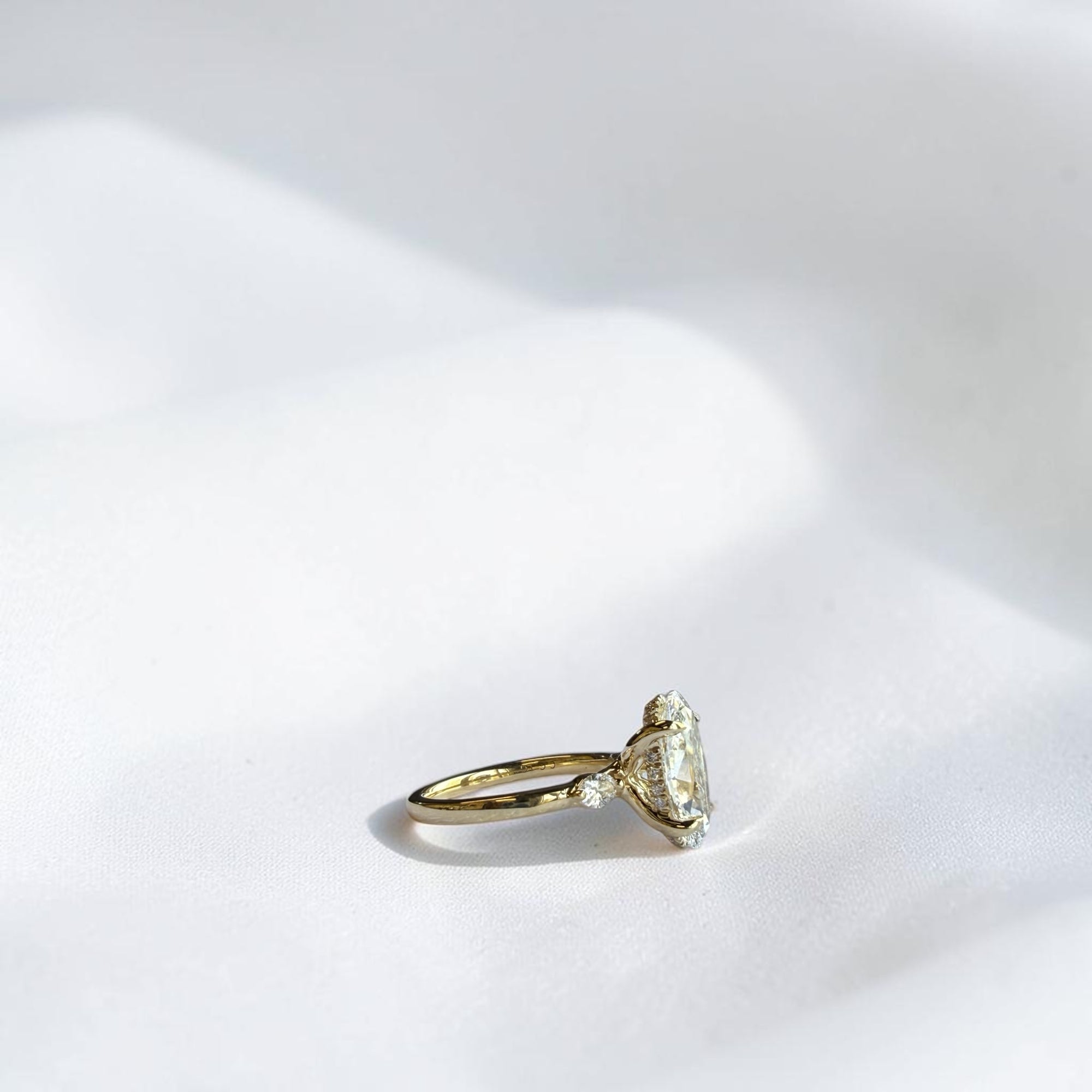 Moval Crown engagement ring with marquise side stones and hidden halo in yellow gold — Cherry Pick Diamonds St. Louis