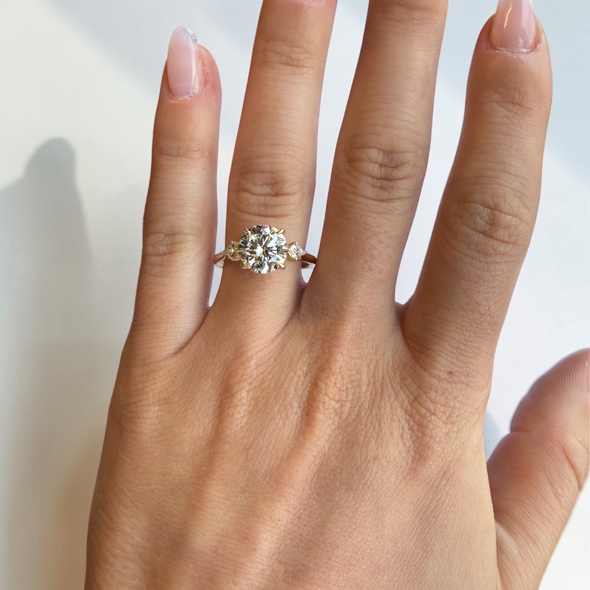 Close-up of Round Trio Kite lab diamond ring with geometric kite side stones in yellow gold — Cherry Pick Diamonds Clayton Missouri
