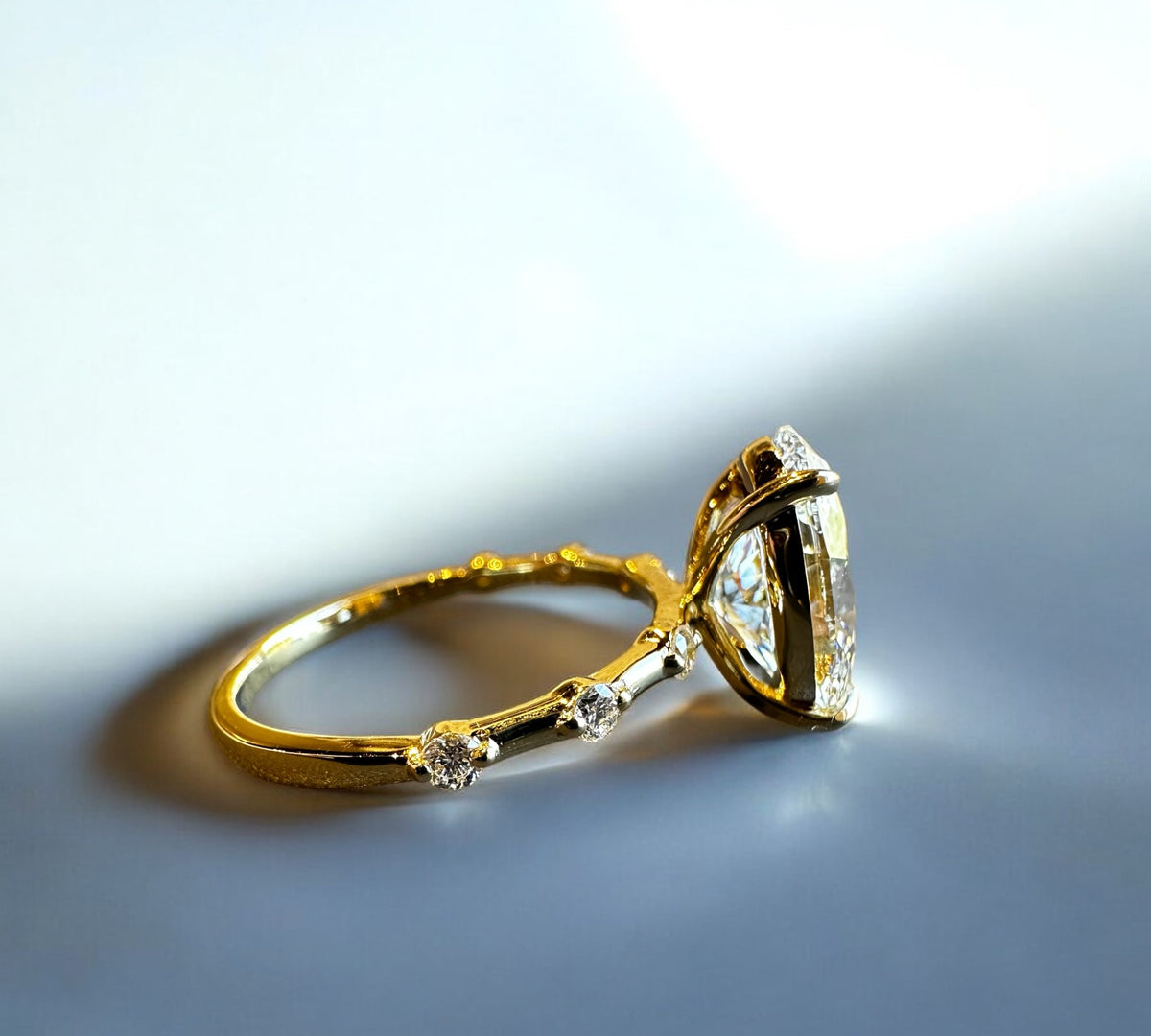 Webster Oval engagement ring side view with floating natural side diamonds – Cherry Pick Diamonds St. Louis MO