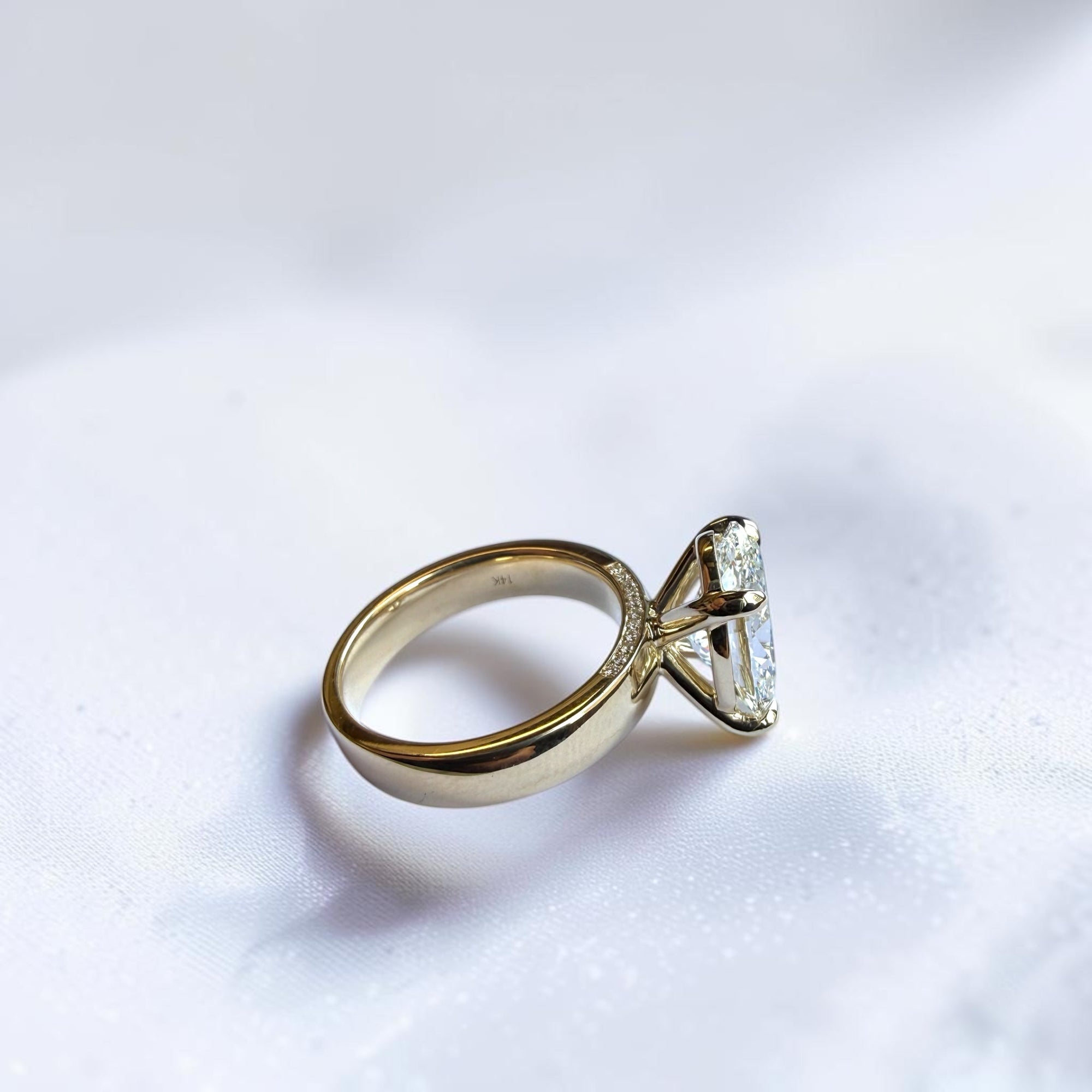 Side profile of oval brilliant lab-grown diamond ring with hidden halo band, St. Louis engagement rings