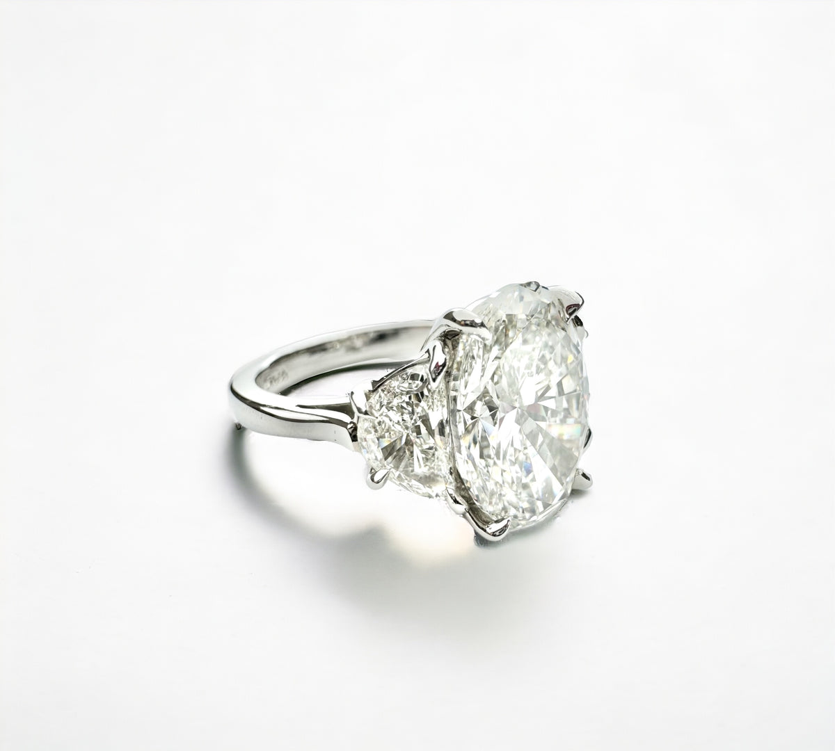Trio Oval 6.42 platinum three stone ring side view with half moon diamonds – Cherry Pick Diamonds St. Louis MO